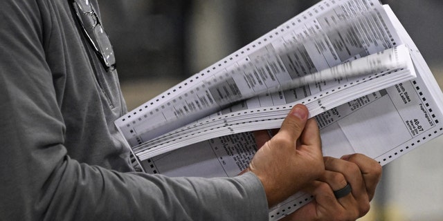Poll workers process ballots at an elections warehouse outside Philadelphia on Nov. 8, 2022.