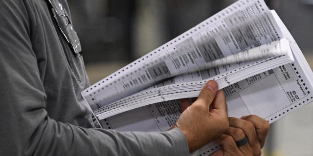 Poll workers process ballots at an elections warehouse outside Philadelphia on Nov. 8, 2022.