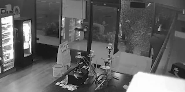 Surveillance footage at a Sarasota County vape shop shows a burglar shooting into the store's front window before stealing the register.