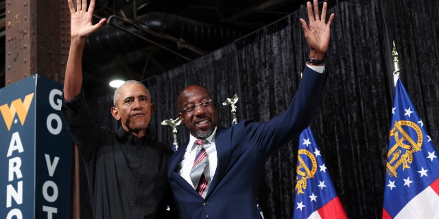 Former President Obama campaigns with Georgia Democratic Senate candidate Sen. Raphael Warnock, D-Ga., at a rally Dec. 1, 2022, in Atlanta.