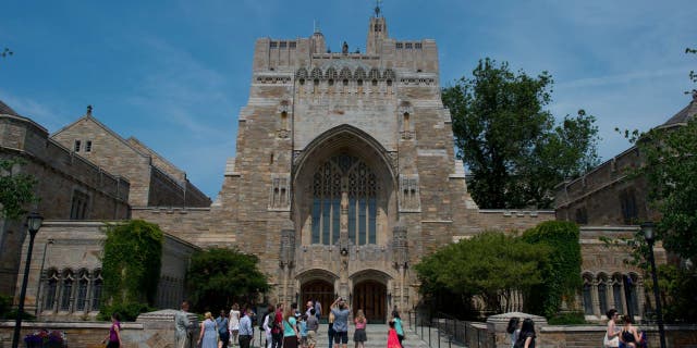 A tour group makes a stop at the Sterling Memorial Library on the Yale University campus in New Haven, Connecticut, June 12, 2015.