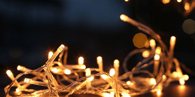 Up close photo of yellow Christmas lights ready for decorative use.