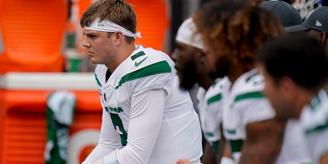 New York Jets quarterback Zach Wilson sits on the bench during the first half of an NFL football game against the Tennessee Titans, Sunday, Oct. 3, 2021, in East Rutherford.