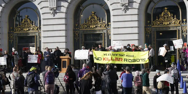 People take part in a demonstration about the use of robots by the San Francisco Police Department outside of City Hall in San Francisco, Monday, Dec. 5, 2022.