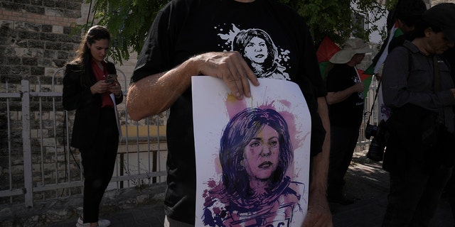 Protesters holding posters for slain Palestinian-American journalist Shireen Abu Akleh in East Jerusalem on July 15.