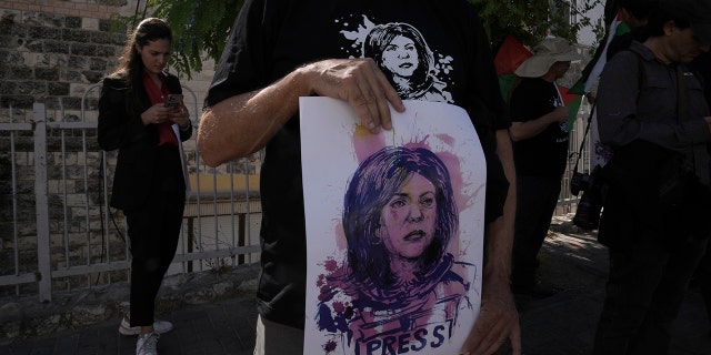 Protesters holding posters for slain Palestinian-American journalist Shireen Abu Akleh in East Jerusalem on July 15.