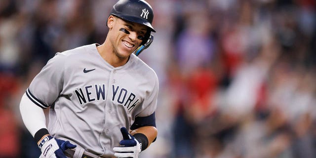 Aaron Judge of the New York Yankees walks around the bases after hitting his 62nd home run of the season against the Rangers at Globe Life Field on October 4, 2022 in Arlington, Texas.