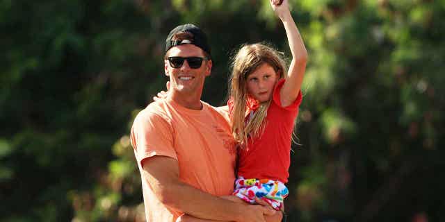 Pictured: Brady celebrates his Super Bowl win with the Tampa Bay Buccaneers with his daughter, Vivian Lake. She is the youngest of Brady’s three children.