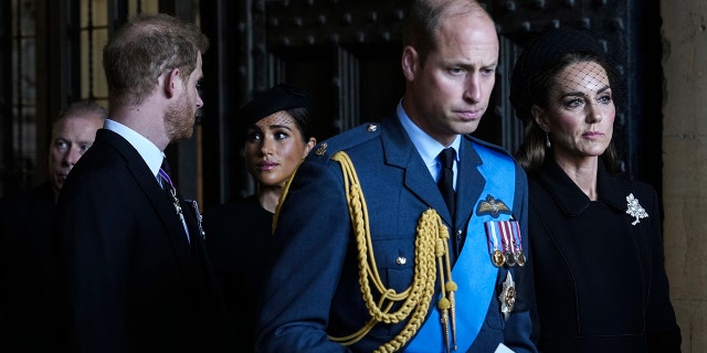 From left: Prince William, Prince of Wales with Catherine, Princess of Wales, and Prince Harry with Meghan, Duchess of Sussex, leave after escorting the coffin of Queen Elizabeth II from Buckingham Palace to Westminster Hall on Sept. 14, 2022, in London.