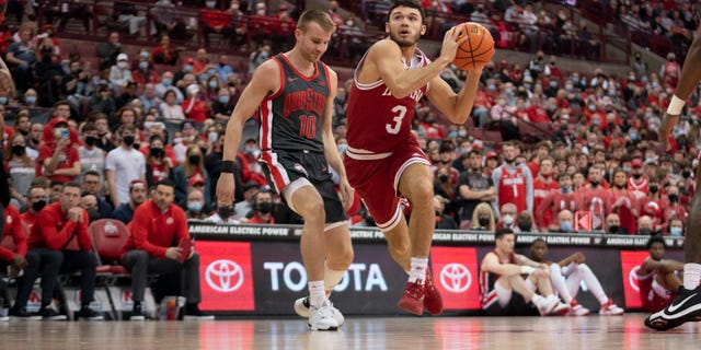 Indiana Hoosiers guard Anthony Leal #3 drives to the basket around Ohio State Buckeyes forward Justin Ahrens #10 during the game between the Ohio State Buckeyes and the Indiana Hoosiers at Value City Arena in Columbus, Ohio on February 21, 2022.
