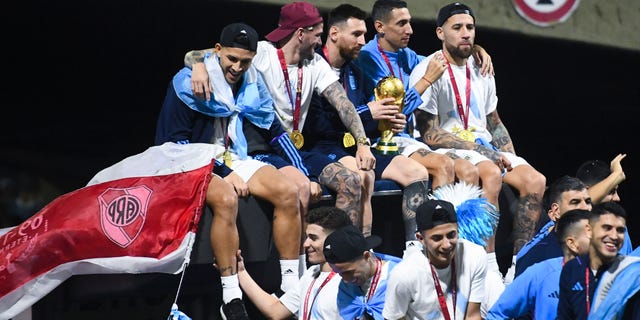 World Cup champions, from left, Leandro Paredes, Rodrigo De Paul, Lionel Messi, Angel Di Maria and Nicolas Otamendi celebrate on Dec. 20, 2022, in Buenos Aires, Argentina.