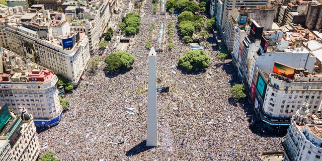 Fans wait at the Obelisk on Dec. 20, 2022, in Buenos Aires for the victory parade for Argentina's soccer team, which won the World Cup in Qatar.