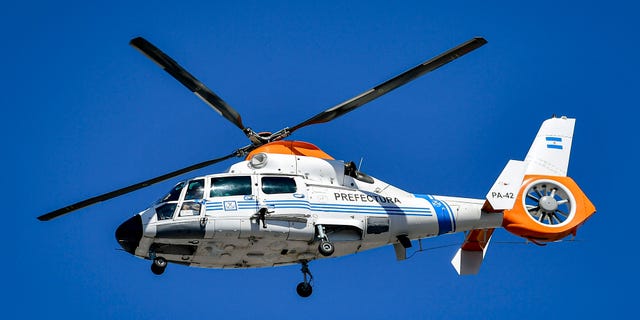 Players ride in a helicopter over the fans during a victory parade of the World Cup-winning Argentina men's national team on Dec. 20, 2022, in Buenos Aires.