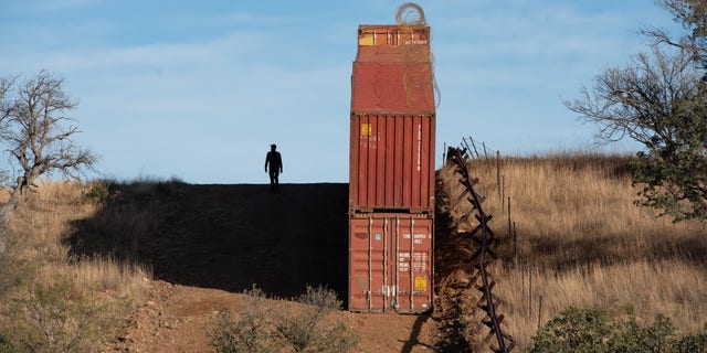 Shipping containers and vehicle barriers line the US-Mexico border at Coronado National Monument in Cochise County, Arizona on December 11, 2022.