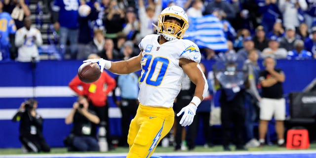 Austin Ekeler #30 of the Los Angeles Chargers celebrates after a touchdown against the Indianapolis Colts at Lucas Oil Stadium on December 26, 2022, in Indianapolis, Indiana.