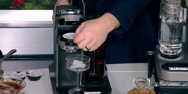 Bartesian founder and CEO Ryan Close pops a drink pod into a Bartesian cocktail maker on "Fox and Friends" on Dec. 19, 2022.