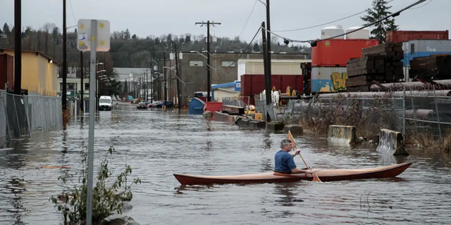 A person kayaks on South Portland Street in Seattle's South Park neighborhood Tuesday morning, Dec. 27, 2022. 