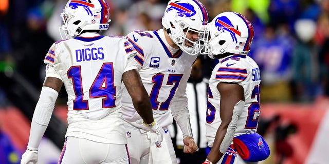 Quarterback Josh Allen #17 celebrates with running back Devin Singletary #26 of the Buffalo Bills after Singletary rushed for a fourth quarter touchdown against the New England Patriots at Gillette Stadium on December 01, 2022 in Foxborough, Massachusetts.