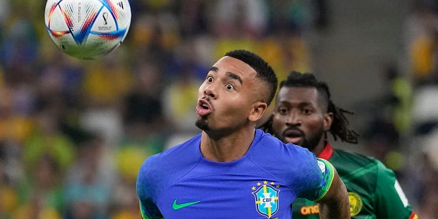 Brazil's Gabriel Jesus, front, and Cameroon's Andre-Frank Zambo Anguissa fight for the ball during a World Cup Group G game at Lusail Stadium in Lusail, Qatar, Friday, Dec. 2, 2022.Â
