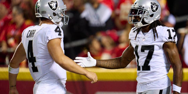 Davante Adams (17) of the Las Vegas Raiders celebrates after scoring a touchdown with teammate Derek Carr (4) against the Kansas City Chiefs during the second half at GEHA Field at Arrowhead Stadium on October 10, 2022 in Kansas City, Missouri.