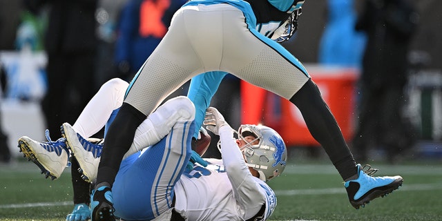 Brian Burns #53 of the Carolina Panthers sacks Jared Goff #16 of the Detroit Lions during the third quarter of the game at Bank of America Stadium on December 24, 2022 in Charlotte, North Carolina.