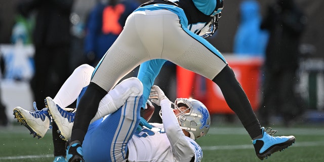 Brian Burns #53 of the Carolina Panthers sacks Jared Goff #16 of the Detroit Lions during the third quarter of the game at Bank of America Stadium on December 24, 2022 in Charlotte, North Carolina.