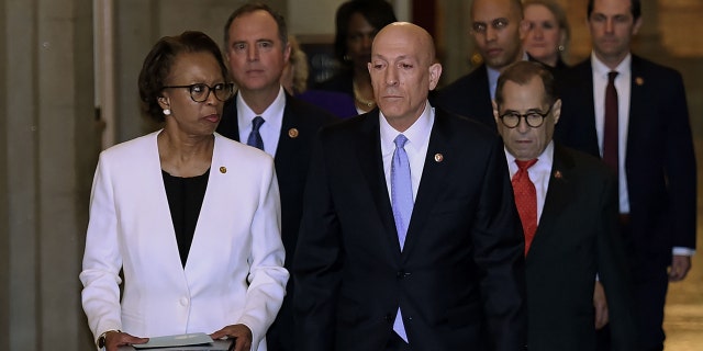 The impeachment articles signed by Speaker of the House Nancy Pelosi are being carried out by the House SAA Paul Irving (R) and House clerk Cheryl Johnson (L) over to Senate side followed by Impeachment Managers on Capitol Hill January 15, 2020, in Washington, DC. - The US House of Representatives voted Wednesday to transmit articles of impeachment against President Donald Trump to the Senate, opening the way for the historic trial of the 45th president for abuse of power. (Photo by OLIVIER DOULIERY / AFP) (Photo by OLIVIER DOULIERY/AFP via Getty Images)