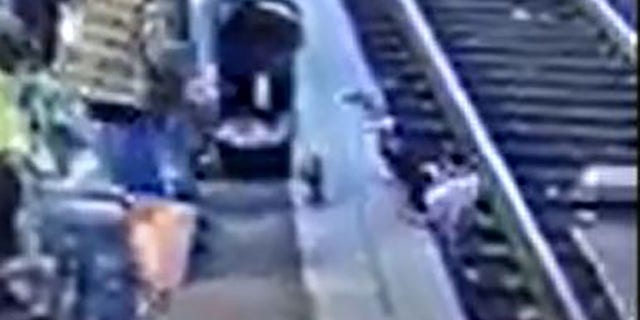 According to the video, the child landed face-first on the tracks. 