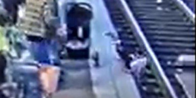 The child landed face-first on the tracks, video shows. 