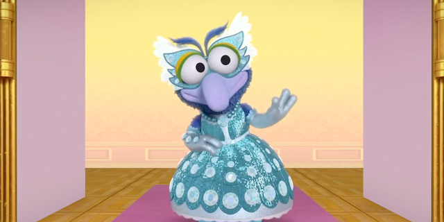 An image from an episode of "Muppets Babies" called "Gonzo-rella" in which the character of Gonzo used they/them pronouns and wears a dress. 