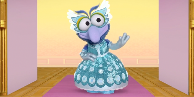 An image from an episode of "Muppets Babies" called "Gonzo-rella" in which the character of Gonzo used they/them pronouns and wears a dress. 