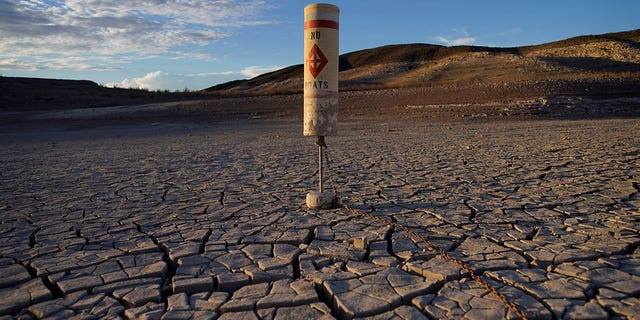The Colorado River saw record drought in the past two decades, according to officials. Pictured:  A buoy sits high and dry on cracked terrain that was previously under water at the Lake Mead National Recreation Area near Boulder City, Nevada, on June 28, 2022.