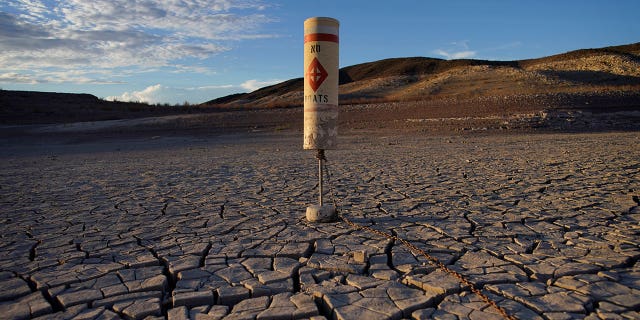 The Colorado River saw record drought in the past two decades, according to officials. Pictured: A buoy sits high and dry on cracked terrain that was previously under water at the Lake Mead National Recreation Area near Boulder City, Nevada, on June 28, 2022.