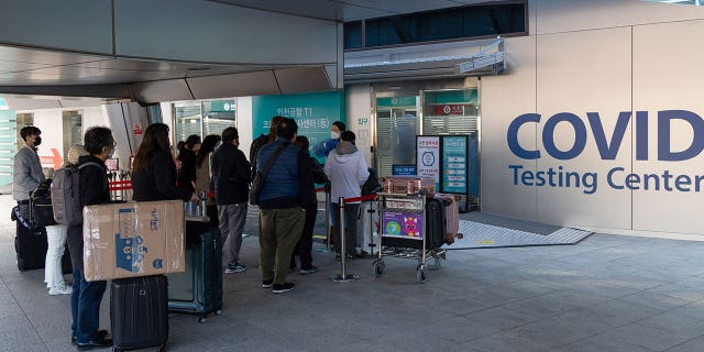 From the beginning of January, travelers arriving from China must submit a negative result of a rapid antigen test performed within 24 hours or a PCR test no more than 48 hours before departure. They must also undergo another PCR test upon arrival. Pictured: Passengers queue at a COVID testing center at Incheon International Airport, South Korea, on December 3, 2021.