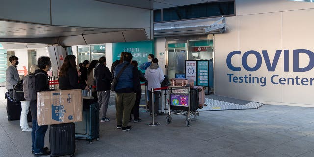 Starting early January, travelers arriving from China would need to submit a negative result from a rapid antigen test taken within 24 hours or a PCR test no more than 48 hours before departure. They also must undergo another PCR test upon arrival. Pictured: Passengers queue in line at a COVID testing center in Incheon International Airport, South Korea, on Dec. 3, 2021.