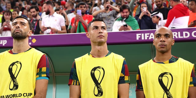 Cristiano Ronaldo of Portugal, center, looks on from the bench prior to a FIFA World Cup Qatar 2022 round of 16 match between Portugal and Switzerland at Lusail Stadium Dec. 6, 2022, in Lusail City, Qatar.