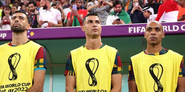 Cristiano Ronaldo of Portugal, center, looks on from the bench prior to a FIFA World Cup Qatar 2022 round of 16 match between Portugal and Switzerland at Lusail Stadium Dec. 6, 2022, in Lusail City, Qatar.