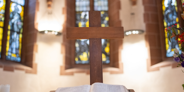 A wooden cross stands on the altar in the Lutheran Old St. Nicholas Church in Frankfurt, Germany, Nov. 23, 2022.