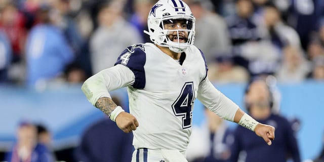 Dak Prescott #4 of the Dallas Cowboys touches scored by Dalton Schultz #86 against the Tennessee Titans during the fourth quarter of the game at Nissan Stadium in Nashville, Tennessee on December 29, 2022. Celebrate down.
