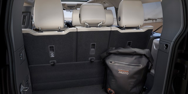 A small cargo area sits behind the third row.