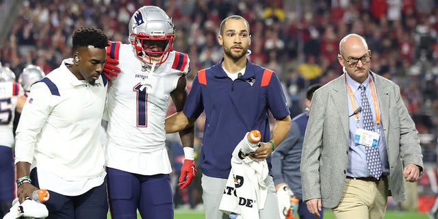 DeVante Parker, #1 of the New England Patriots, is assisted off the field after a play against the Arizona Cardinals during the first quarter of the game at State Farm Stadium on Dec. 12, 2022 in Glendale, Arizona.