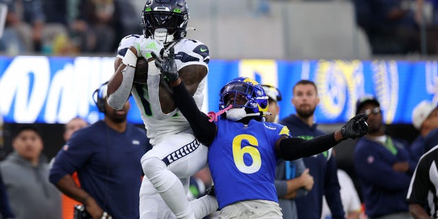 DK Metcalf of the Seattle Seahawks makes a catch over Derion Kendrick of the Los Angeles Rams during the third quarter at SoFi Stadium on Dec. 4, 2022, in Inglewood, California.