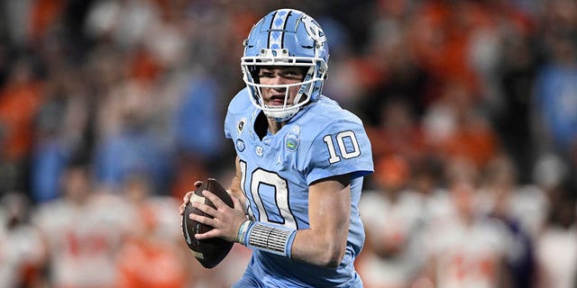 Drake Maye (10) of the North Carolina Tar Heels runs the ball against the Clemson Tigers in the second quarter during the ACC championship game at Bank of America Stadium Dec. 3, 2022, in Charlotte, N.C.