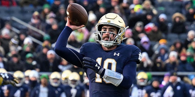 Quarterback Drew Pyne of the Notre Dame Fighting Irish throws a touchdown in the first half against the Boston College Eagles at Notre Dame Stadium in South Bend, Indiana, on Nov. 19, 2022.