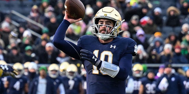 Quarterback Drew Pyne of the Notre Dame Fighting Irish throws a touchdown in the first half against the Boston College Eagles at Notre Dame Stadium in South Bend, Indiana, on Nov. 19, 2022.