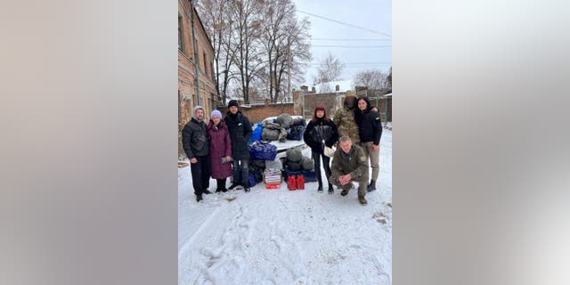 Volunteers Anastasiya and Ihor, with Evil Cannot Enter Heaven, delivering aid in Ukraine, December 2022.