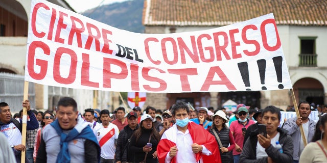 Demonstrators carry a sign reading, "Closure of the coup Congress," amid violent protests following the ousting and arrest of former President Pedro Castillo, in Ayacucho, Peru December 15, 2022. 