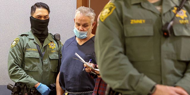 Eric Holland, who has an extensive criminal history, killed and dismembered his friend Richard Miller. Pictured: Eric Holland stands in court at the Regional Justice Center in Las Vegas, Nevada, on Dec. 28, 2021.