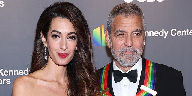 George Clooney and wife Amal Clooney smile on red carpet in Washington D.C.