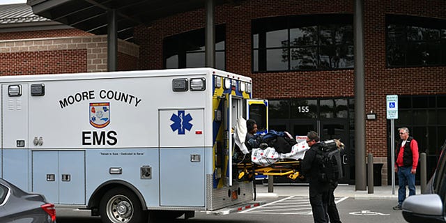 An ambulance is seen in front of a hospital without electricity as tens of thousands are without power in Moore County, North Carolina.